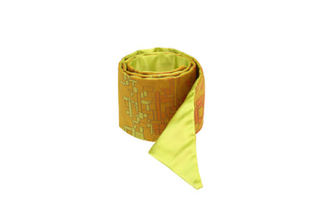 Rolled yellow silk Mimi Fong skinny scarf with yellow & orange geometric cubes pattern on white background