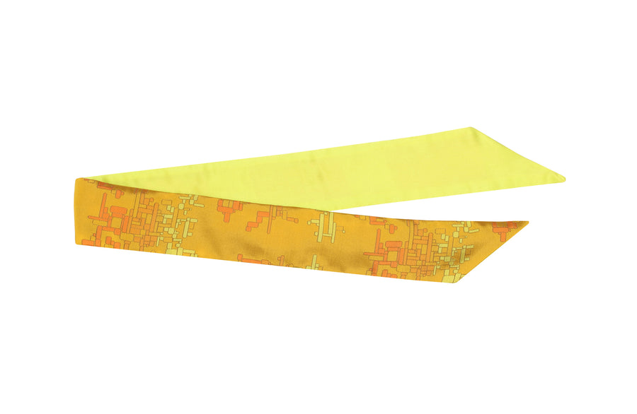 Folded flat yellow silk Mimi Fong skinny scarf with yellow & orange geometric cubes pattern on white background