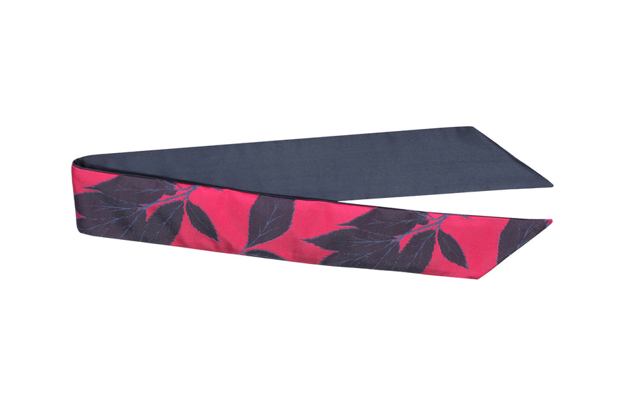 Magenta silk Mimi Fong skinny scarf with blue leaves pattern on white background