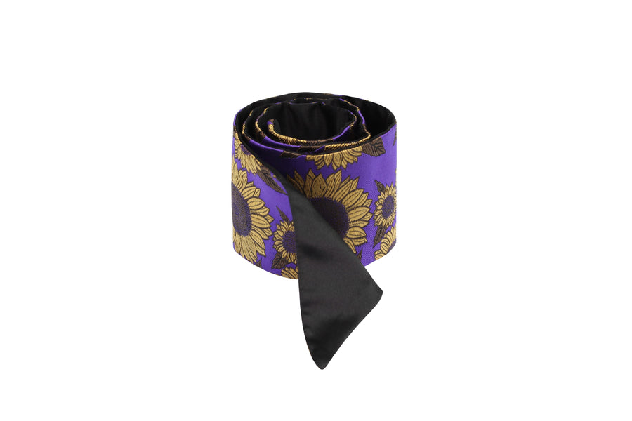 Rolled purple & black silk Mimi Fong skinny scarf with gold sunflower pattern on white background